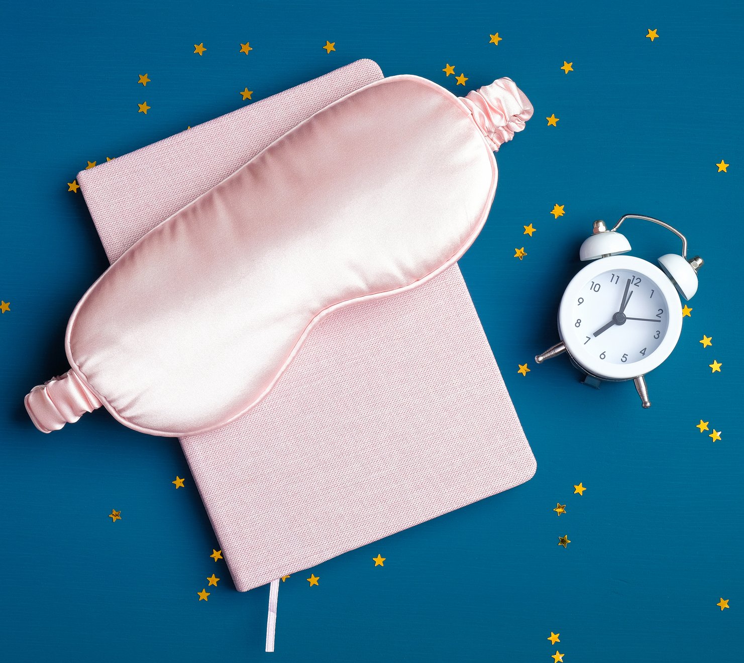 pink sleep mask on blue