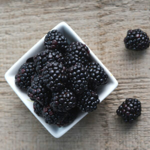 full bowl of ripe fresh blackberries, closeup